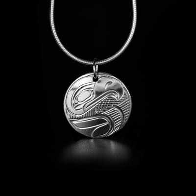 Round Sterling Silver Eagle Pendant hand-carved by Kwakwaka'wakw artist Victoria Harper. Pendant measures approximately 0.80" x 0.70" including bail. Chain not included.