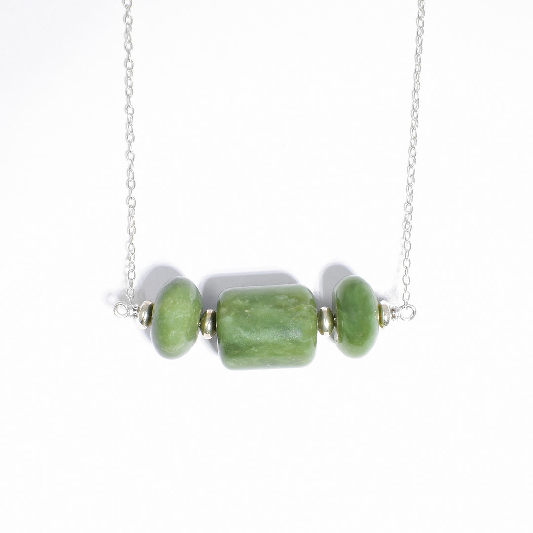 Set of three BC jade beads across, separated by little sterling silver rondelle beads. Central cylindrical jade bead between two rondelle jade beads. Pendant is in place.