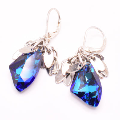 Funky lever back earrings handcrafted by artist Karley Smith. Made of sterling silver and Bermuda Blue Swarovski Crystal. Ear hooks are sterling silver. Each earring measures 1.55" x 0.40" including hook.