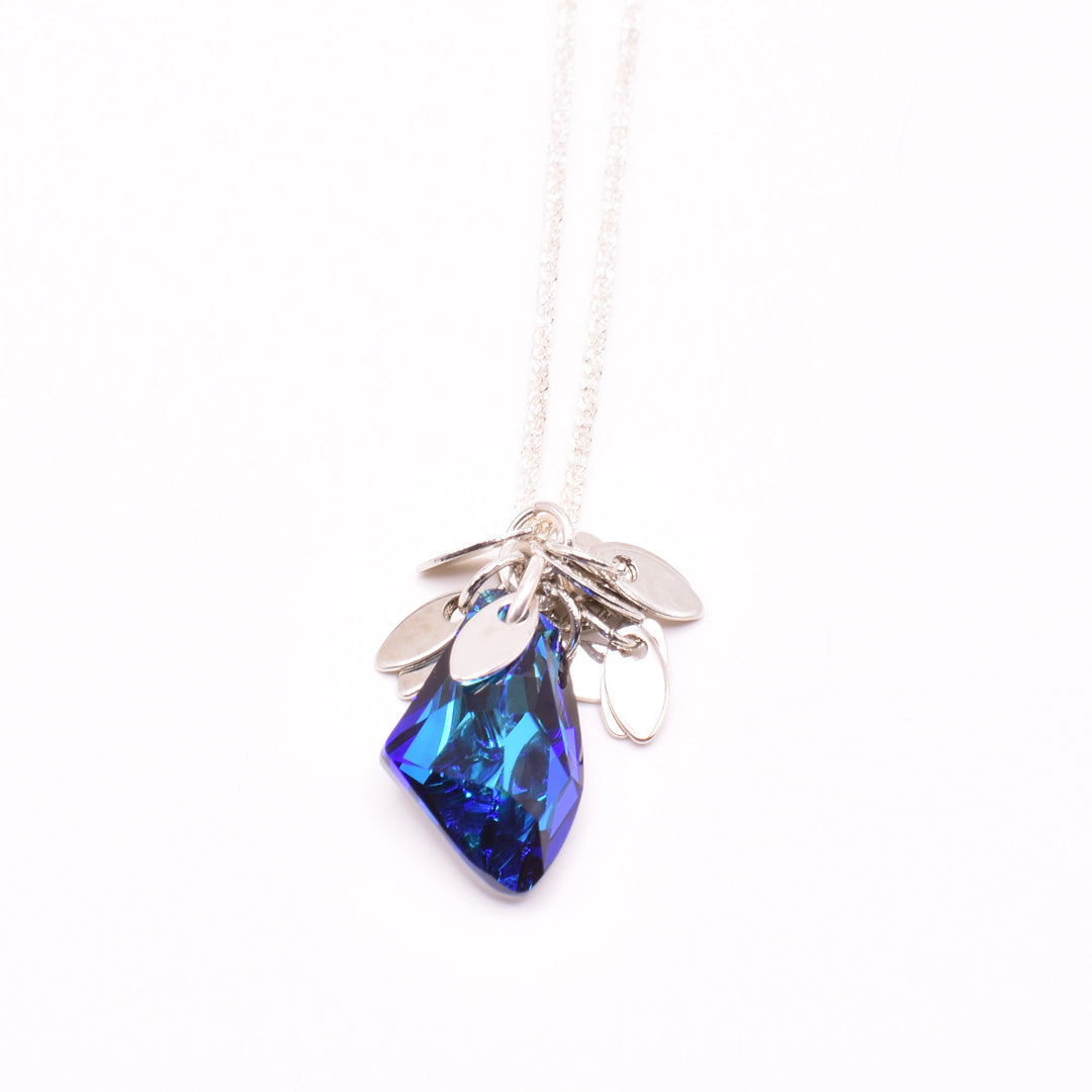 Unique crystal pendant necklace handcrafted by artist Karley Smith. Pendant made of sterling silver and Bermuda Blue Swarovski Crystal. Sterling silver chain included. Pendant measures 1.1" x 0.4" including bail. Chain is 15.5" long with 2.5" extender.