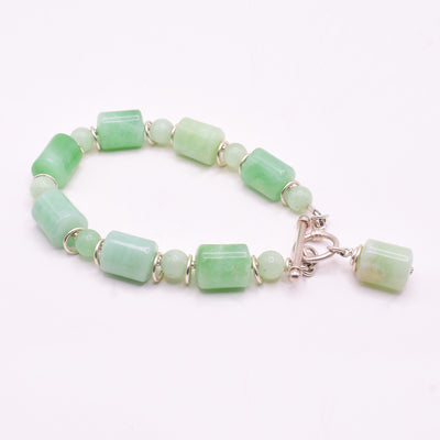 Silver Burma Jade Bracelet handcrafted by artist Karley Smith. Made of sterling silver and Burma Jade. It closes with a toggle clasp. Bracelet is 7.25" long and 0.38" wide.