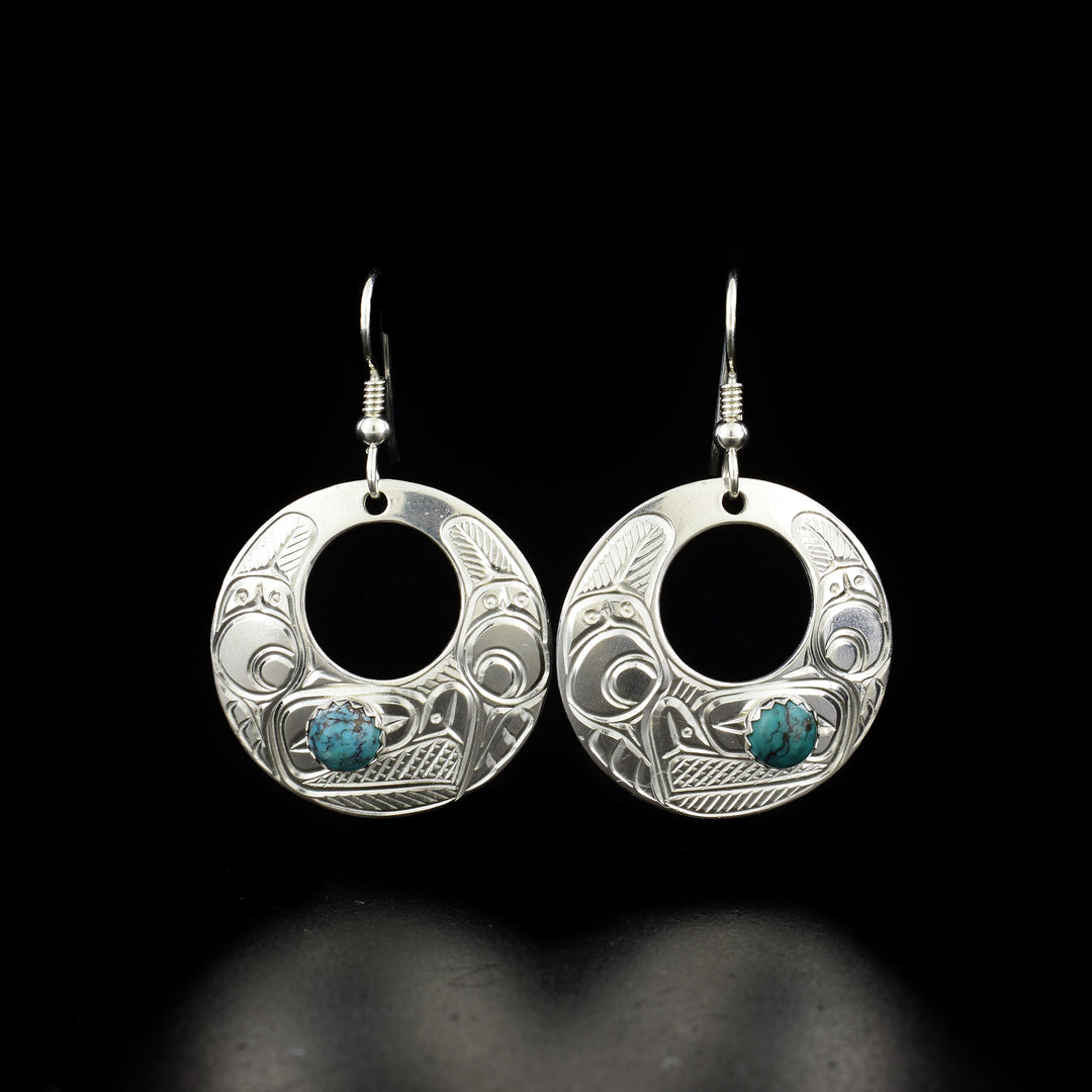 Silver Eagle Cut Out Earrings with Turquoise hand-carved by Coast Salish and Cree artist Richard Lang. Made of sterling silver and turquoise. Each earring measures 1.75" x 1" including hook.