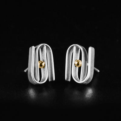 Silver and Gold Equilibrium Stud Earrings handcrafted by artist Lynda Constantine. Made of sterling silver and 14K gold. Each earring measures 0.50" x 0.30".