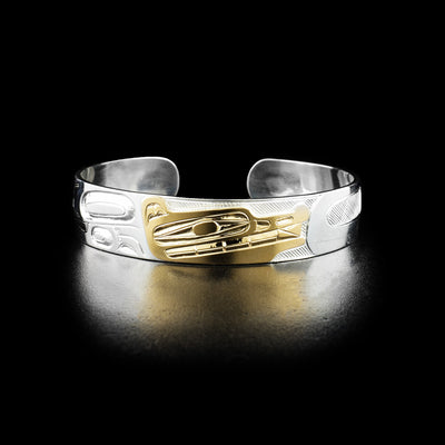 Detailed wolf cuff bracelet hand-carved by Indigenous artist Ivan Thomas. Made of sterling silver and 14K gold. Bracelet is 6.19" long with 0.63" gap and has width of 0.50".