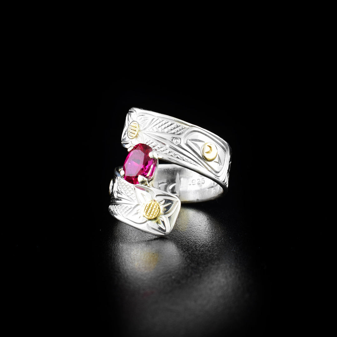 Hummingbird wrap ring hand-carved by artist Richard Lang. Made of sterling silver, 14K gold and a lab-grown stone. Band is 0.31" wide, with the flexible wrap design giving the ring a comfortable fit. Size 8.