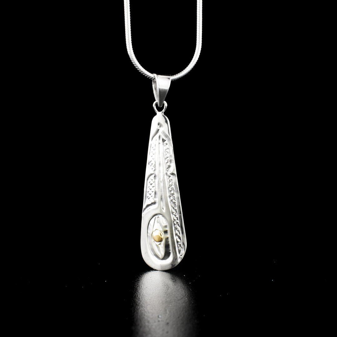 Long teardrop hummingbird pendant hand-carved by Kwakwaka'wakw artist Carrie Matilpi. Made of sterling silver and 14K gold. Pendant measures 1.80" x 0.45" including bail. Chain not included.