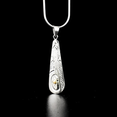 Long teardrop hummingbird pendant hand-carved by Kwakwaka'wakw artist Carrie Matilpi. Made of sterling silver and 14K gold. Pendant measures 1.80" x 0.45" including bail. Chain not included.