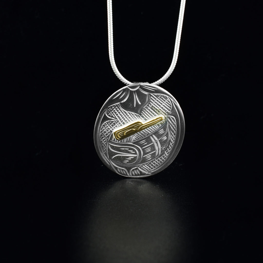This brilliant Hummingbird pendant is made from sterling silver and 14K gold with a circle shape. There are beautiful carvings depicting the Hummingbird made on the surface of the pendant. The face of the Hummingbird is made form gold and is raised like a stud.