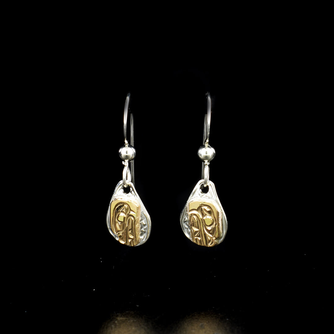 Teardrop bear earrings hand-carved by Kwakwaka'wakw artist Carrie Matilpi. Made of sterling silver and 14K gold. Each earring measures 1" x 0.30" including hook.