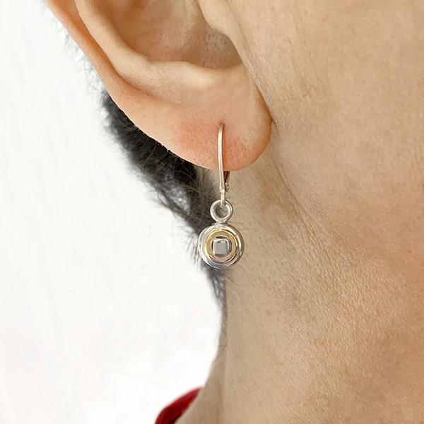 Silver and Gold That's Me Drop Earrings handcrafted by artist Lynda Constantine. Made of sterling silver and 14K gold. Each earring measures 1" x 0.30" including hook.