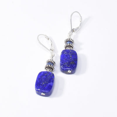 Stunning lever back earrings handcrafted by artist Karley Smith. Made of sterling silver, oxidized silver, Swarovski Crystal and lapis lazuli. Ear hooks are sterling silver. Each earring measures 1.70" x 0.40" including hook.