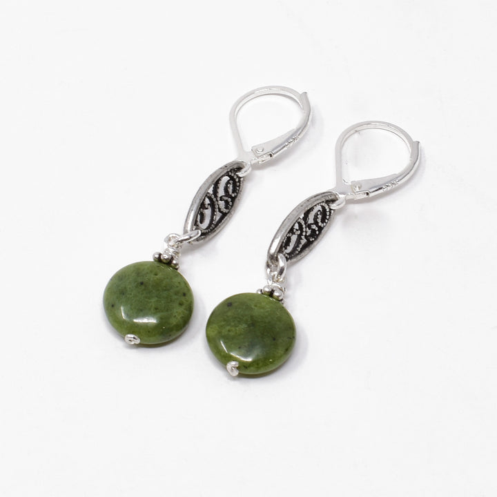 Silver Marquise BC Jade Earrings handcrafted by artist Karley Smith. She has used sterling silver wire, antique jade adornments and BC jade to create the earrings. Ear hooks are sterling silver. Each earring measures 1.63" x 0.38" including hook.