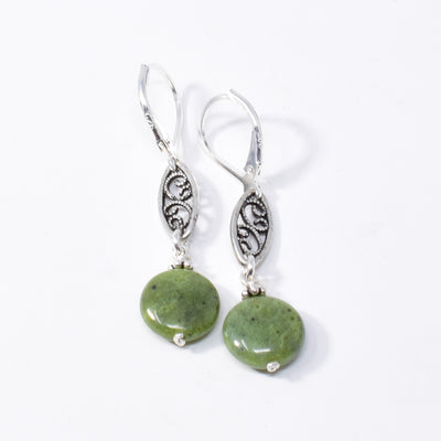 Silver Marquise BC Jade Earrings handcrafted by artist Karley Smith. She has used sterling silver wire, antique jade adornments and BC jade to create the earrings. Ear hooks are sterling silver. Each earring measures 1.63" x 0.38" including hook.