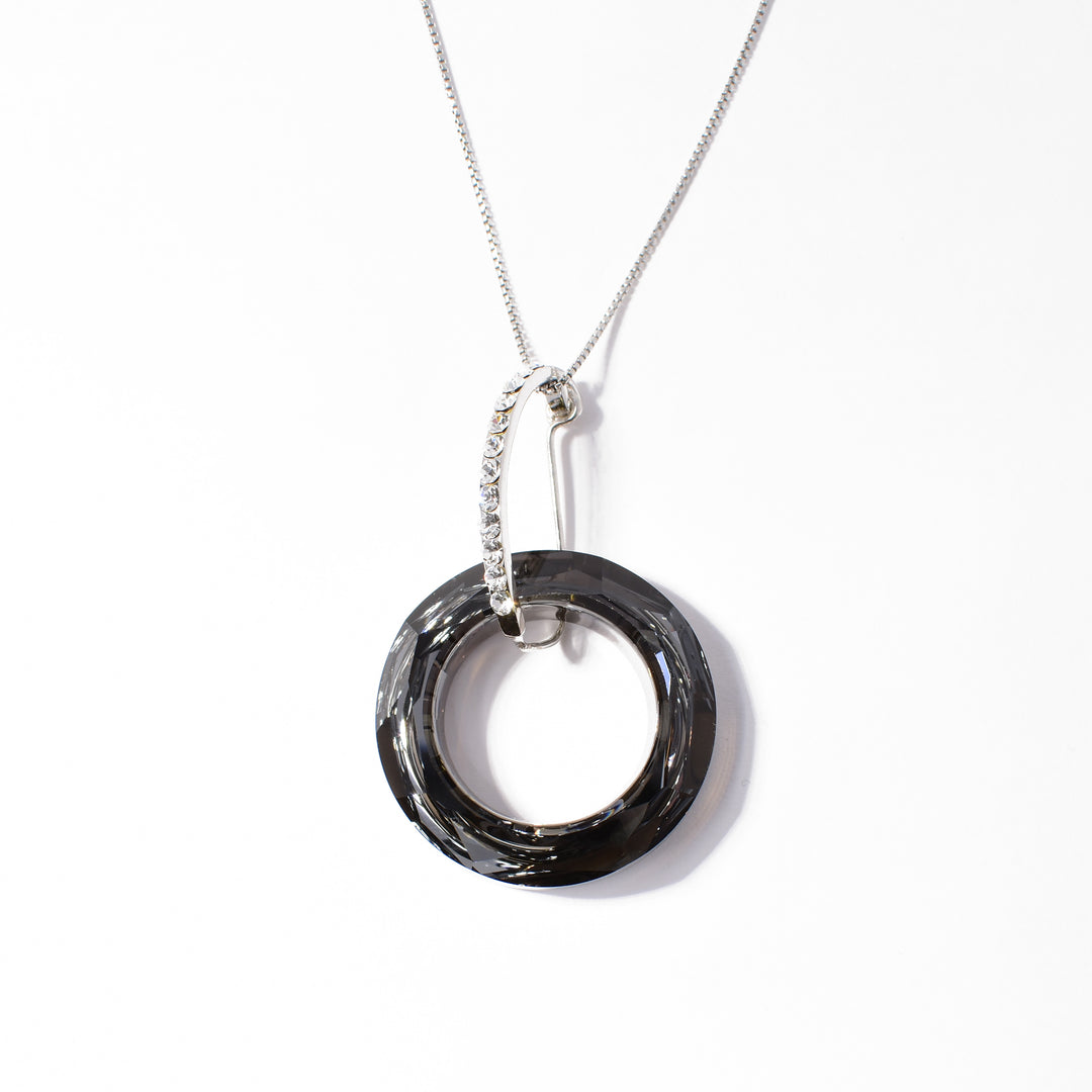 Dazzling pendant handcrafted by artist Debra Nelson. Made of sterling silver, cubic zirconia and silver night Swarovski Crystal. Pendant measures 1.88" x 1.13". Chain not included.