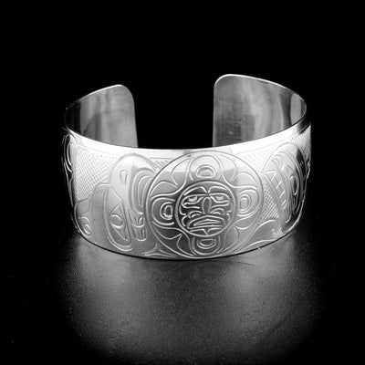 Detailed orca, moon and thunderbird bracelet hand-carved by Kwakwaka'wakw artist John Lancaster. Made of sterling silver. Bracelet is 6.1" long with 0.8" gap and has width of 1".