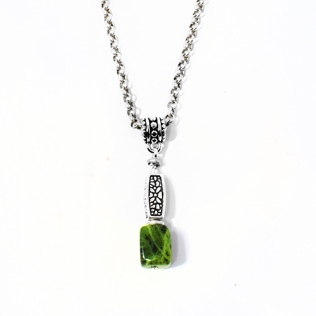 Unique Silver Pebble Pattern Jade Pendant Necklace handcrafted by artist Karley Smith. Pendant is made of sterling silver, oxidized silver, antique silver and BC jade. Antique silver Rolo chain included. Pendant measures 1.50" x 0.25" including bail. Chain is 20" long.