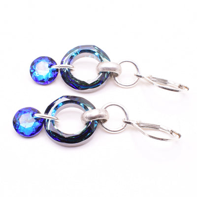 Dazzling lever back earrings handcrafted by artist Karley Smith. Made of sterling silver and Swarovski Crystal. Ear hooks are sterling silver. Each earring measures 1.75" x 0.60" including hook.