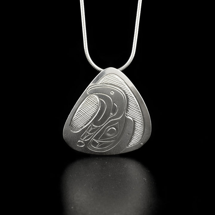 Silver Triangle Eagle Head Pendants hand-carved by Kwakwaka'wakw artist Don Lancaster. Made of sterling silver. There are two pendants to choose from: one where the eagle is facing upwards and one where the eagle is facing left. Each pendant measures 1.40" x 1.25" and has hidden bail on back. Chain not included.