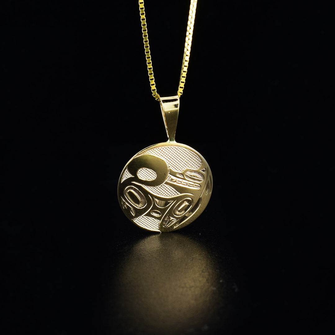 Small 14K gold round wolf pendant hand-carved by artist Ivan Thomas. Pendant measures 1" x 0.63" including bail. Chain not included.