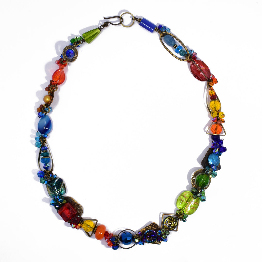 Made of carnelian agate, Swarovski crystal, lampworked glass, freshwater pearls, handworked brass, handmade art glass, hematine, agate, glass, amber and goldstone. 22.25" long.
