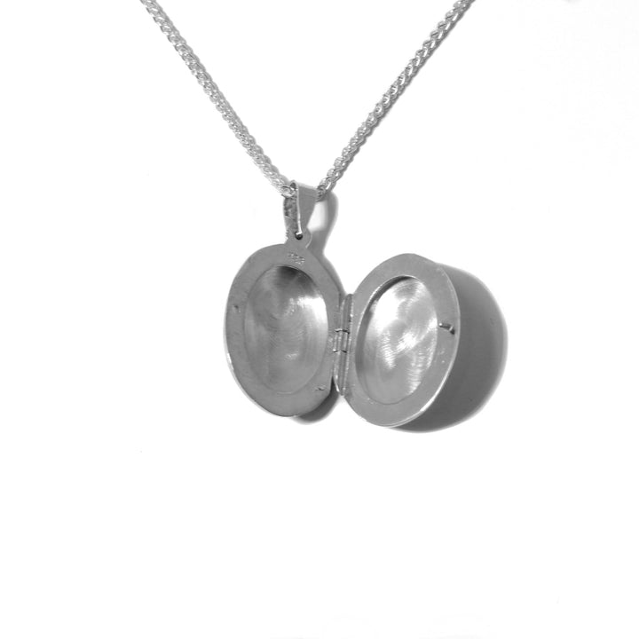 This Small Oval Satin Locket is handmade by artist Pamela Lauz. The locket measures 1.18" x 0.6". The chain is not included.