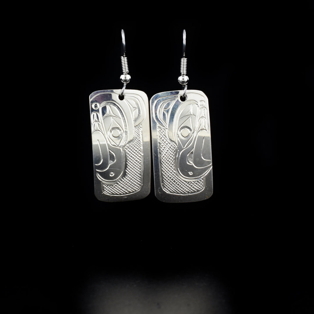 Small Rectangular Thunderbird Earrings hand-carved by Kwakwaka'wakw artist Don Lancaster. Made of sterling silver. Each earring measures 1.8" x 0.6" including hook.