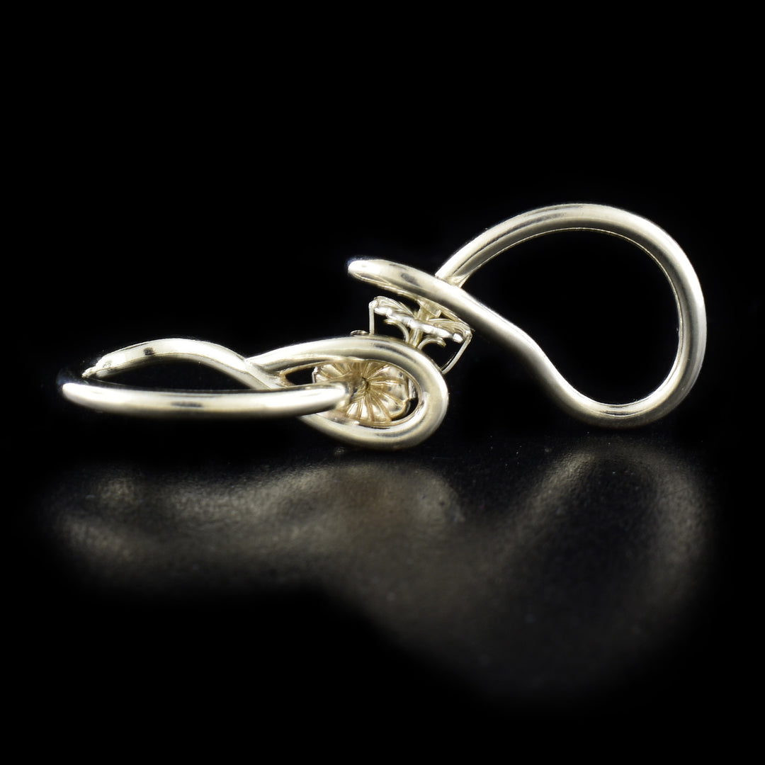 Delicate stud earrings handcrafted by artist Lynda Constantine. Made of sterling silver. Each earring measures 0.94" x 0.25".