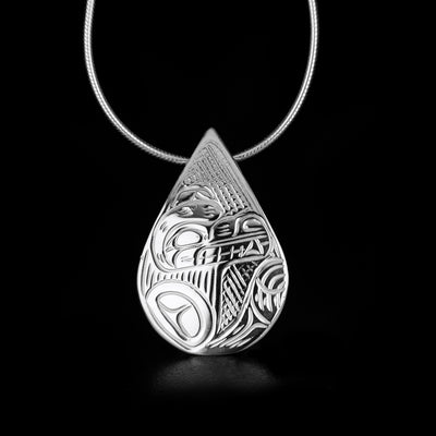 Delicate teardrop bear pendant hand-carved by Kwakwaka'wakw artist Victoria Harper. Made of sterling silver. Pendant measures 1.20" x 0.80". Hidden bail on back. Chain not included.