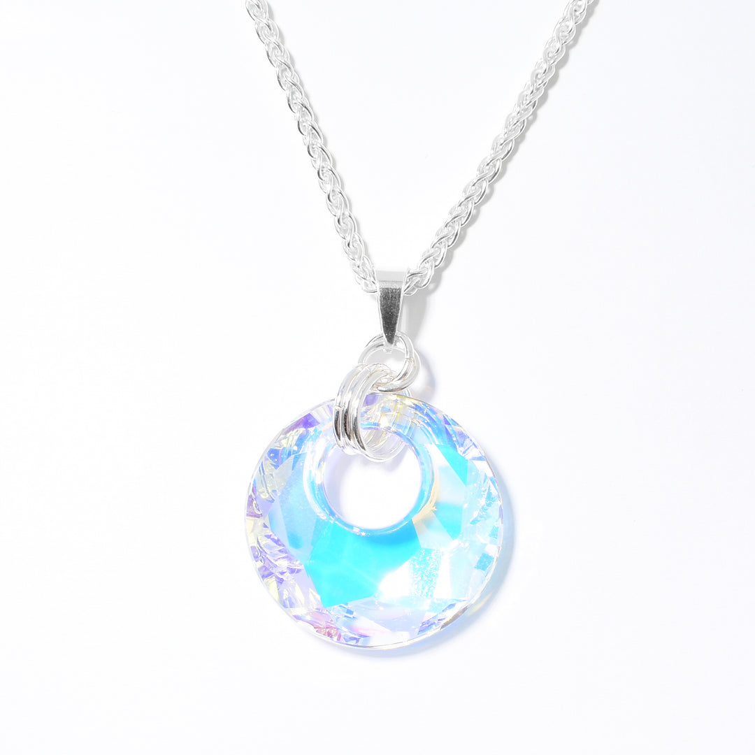 Small Victory Swarovski Crystal Medium Pendant handcrafted by artist Debra Nelson. Made of sterling silver and Aurora Borealis Swarovski Crystal. Pendant measures 1.69" x 1.13" including bail. Chain not included.