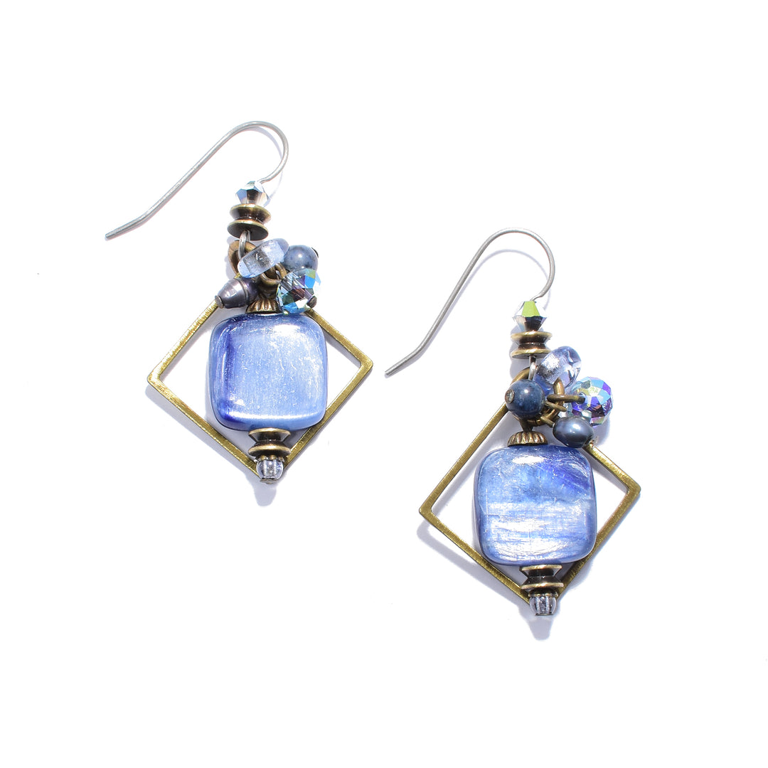 These unique dangling crystal earrings are made from freshwater pearl, lampworked glass, handworked brass, Austrian crystal, dumortierite, kyanite and glass. The hangs are made from a diamond shaped brass hoop, an oval shaped dumortierite gem and kyanite, glass and brass beads and charms.