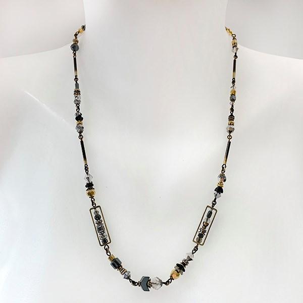 This unique crystal bead necklace is made from hand worked brass, glass, hematine and Austrian crystals. The chains and attachments are made form brass and the necklace is made form unique beads of serval different materials and shapes. 