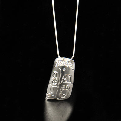 Sterling silver abstract eagle pendant hand-carved by Kwakwaka'wakw artist Harold Alfred. Pendant measures 1.80" x 1". Hidden bail on back. Chain not included.
