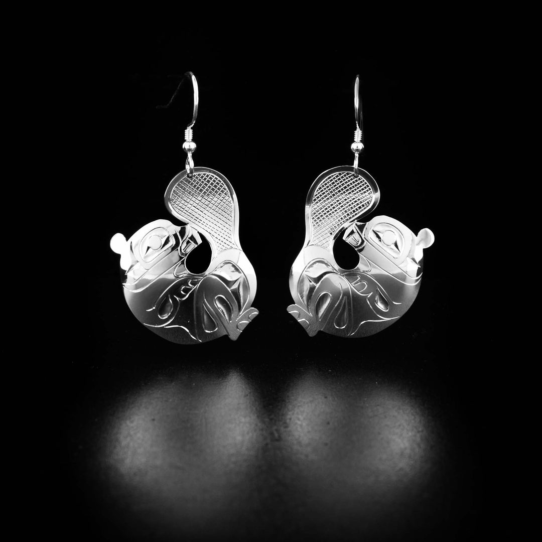 Unique beaver earrings hand-carved by Tlingit artist Fred Myra. Made of sterling silver. Each earring measures 1.8" x 1" including hook.