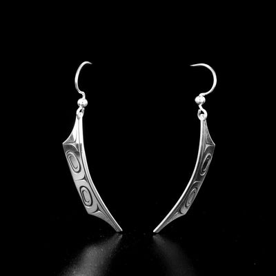 Canoe earrings by Tahltan artist Grant Pauls. Made of sterling silver. Each earring measures 1.95" x 0.25" including hook.