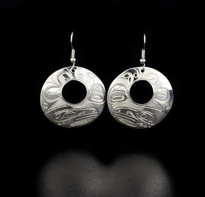 Detailed circle raven cut out earrings hand-carved by Kwakwaka'wakw artist Don Lancaster. Made of sterling silver. Each earring measures 1.94" x 0.31" including hook.