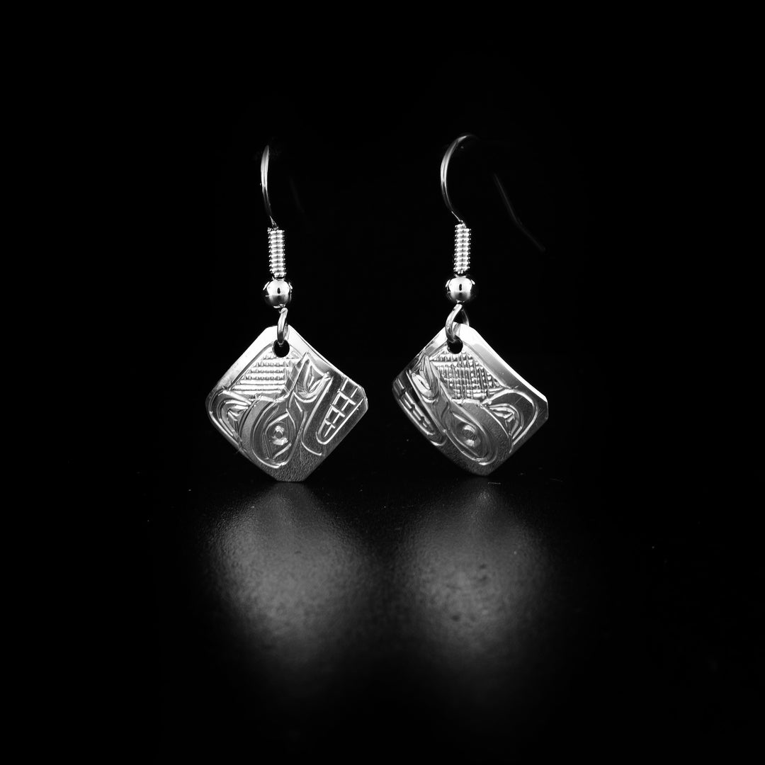 These dangling Wolf earrings are made from sterling silver and have small, diamond shaped hangs. There are depictions of the Wolf carved into the surface of the hangs.
