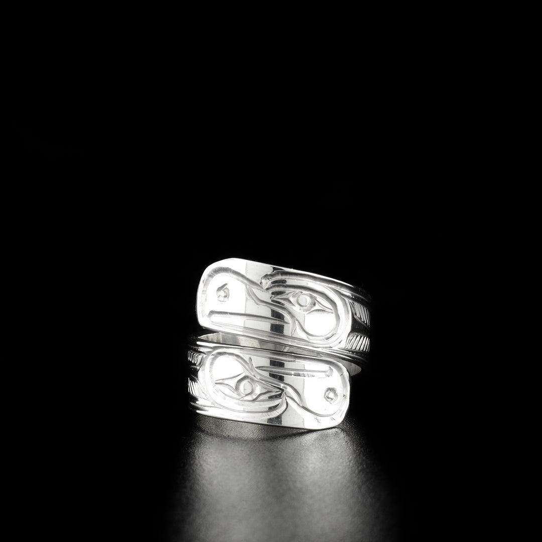 Double eagle wrap ring hand-carved by Kwakwaka'wakw artist Paddy Seaweed. Made of sterling silver. Width of band is 0.31". Size 6.5.
