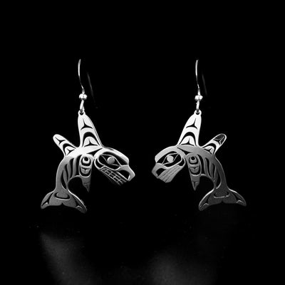 Unique pierced double fin orca earrings by Tahltan artist Grant Pauls. Made of sterling silver. Each earring measures 1.75" x 0.90" including hook.