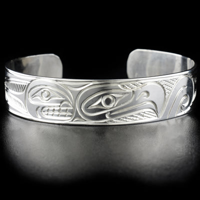Eagle and orca bracelet hand-carved by Kwakwaka'wakw artist Paddy Seaweed. Made of sterling silver. Bracelet is 6.2" long with 0.9" gap and has width of 0.5".