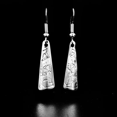 Sterling Silver Triangle Eagle Earrings by Jeffrey Pat. Each earring is in the shape of a triangle. The artist has hand-carved the profile of an eagle's head in each eagle at the bottom of each earring. He has included a feather on the back of the eagle's head.