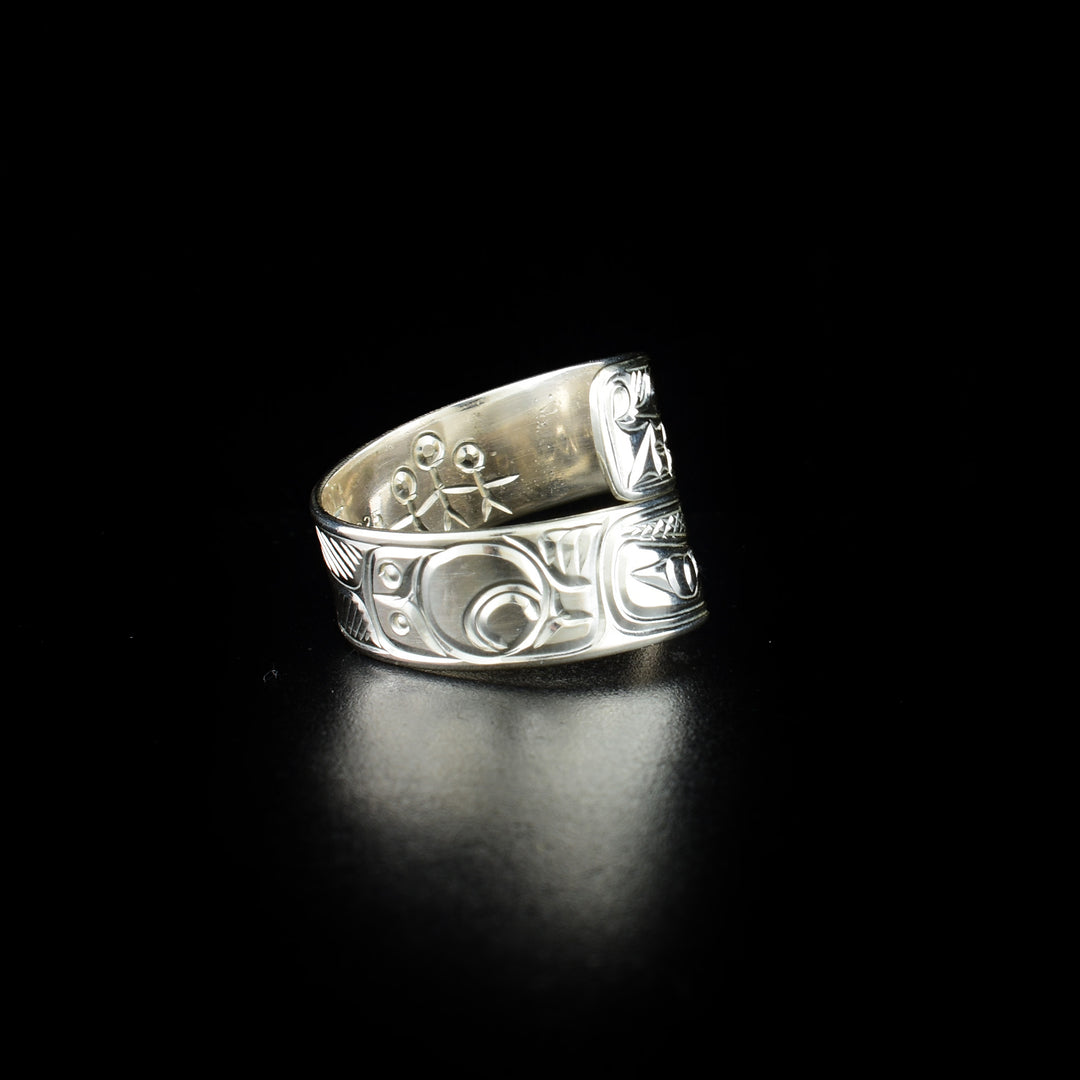 Eagle and wolf wrap ring hand-carved by Coast Salish and Cree artist Richard Lang. Made of sterling silver. Width of band is 0.31". Size 10.5.