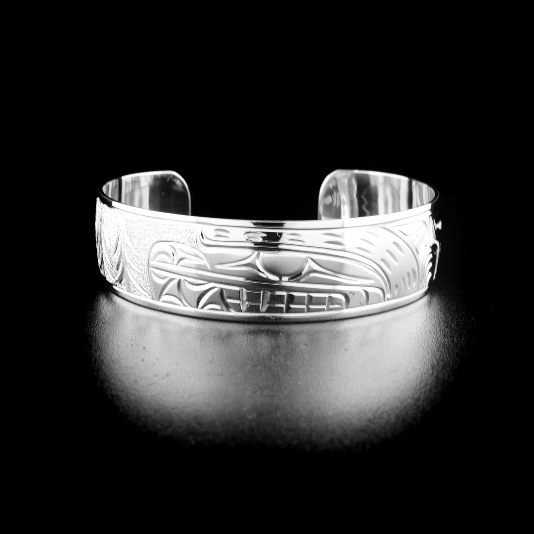 Detailed bear bracelet hand-carved by Kwakwaka'wakw artist Cristiano Bruno. Made of sterling silver. Bracelet is 6.19" long with 1" gap and has width of 0.63".