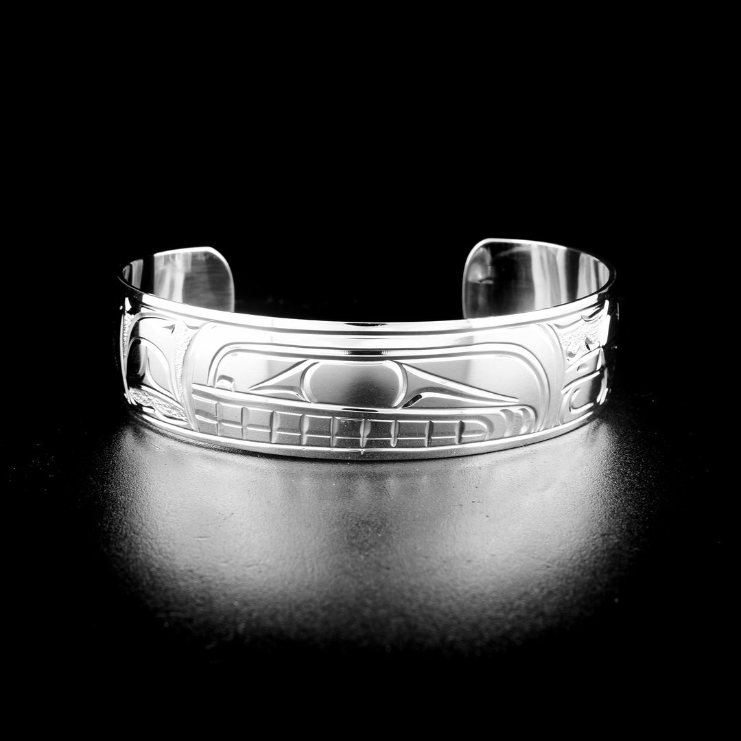 Orca bracelet hand-carved by Kwakwaka'wakw artist Cristiano Bruno. Made of sterling silver. Bracelet is 6.19" long with 1.25" gap and has width of 0.63".