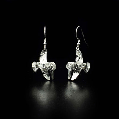 Delicate hummingbird earrings hand-carved by Tlingit artist Fred Myra. Made of sterling silver. Each earring measures 1.4" x 0.6" including hook.
