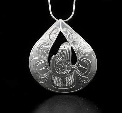 Flying raven pendant hand-carved by Kwakwaka'wakw artist Don Lancaster. Made of sterling silver. Pendant measures 2.25" x 1.94". Hidden bail on back. Chain not included.