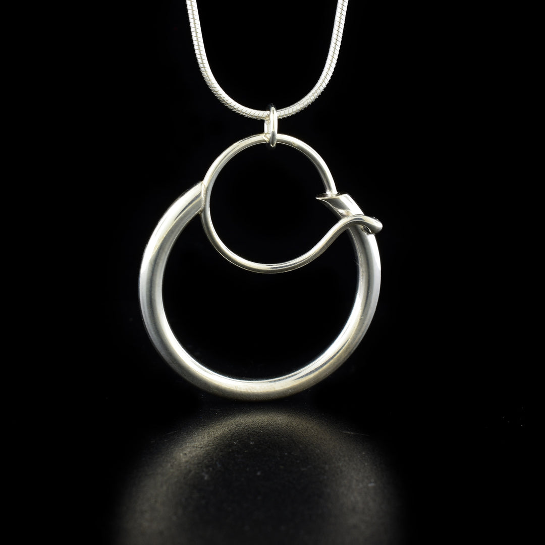 This elegant hoop necklace is made from sterling silver and has a round pendant. There is a large, heavy gauge hoop with a smaller one connected to it at the top. The pendant hangs down from a snake style chain on a small bail.