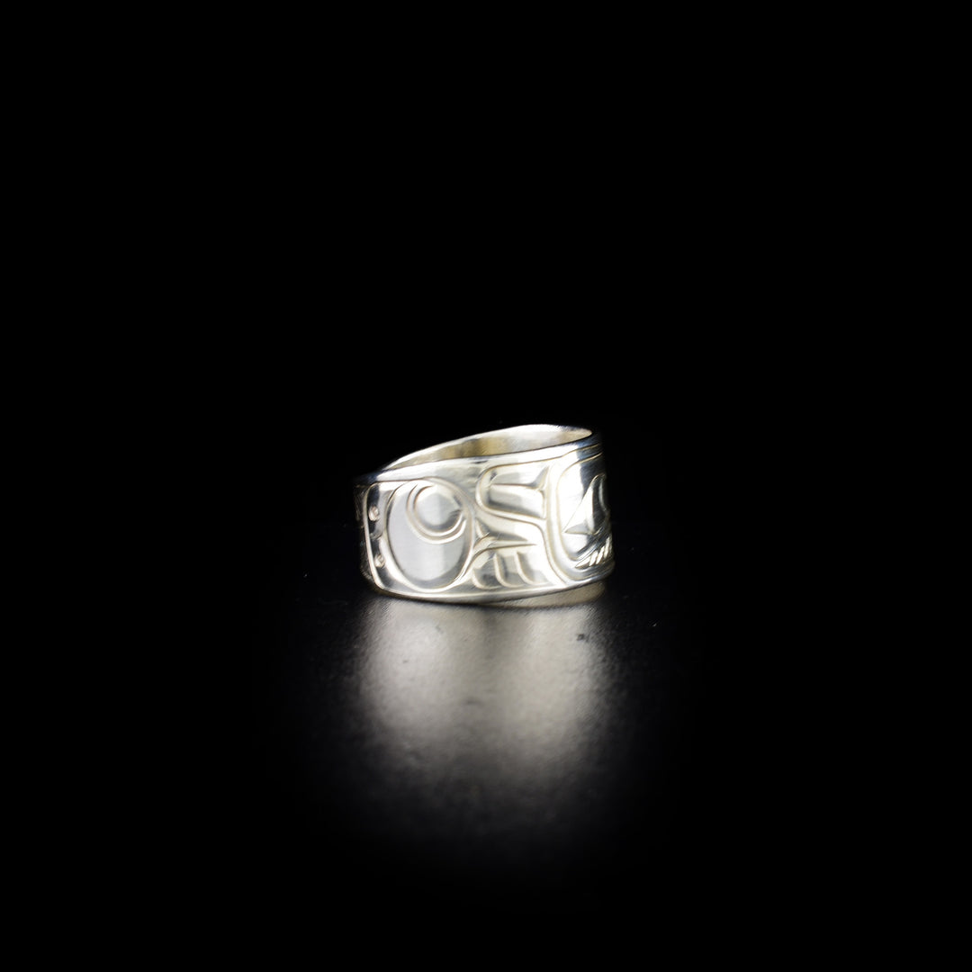 Tapered raven ring hand-carved by Coast Salish and Cree artist Richard Lang. Made of sterling silver. Ring is 0.50" in the front and tapers down to 0.25" in the back. Size 9.5.