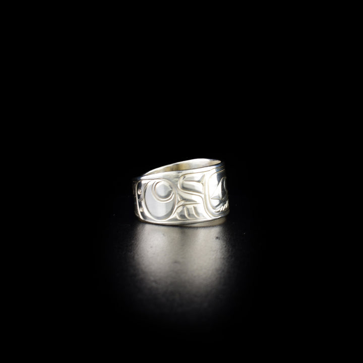 Tapered raven ring hand-carved by Coast Salish and Cree artist Richard Lang. Made of sterling silver. Ring is 0.50" in the front and tapers down to 0.25" in the back. Size 9.5.