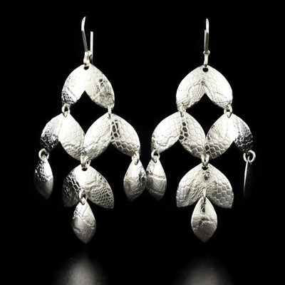 Stunning dangle earrings handcrafted by artist Victoria Poynton. Made of sterling silver. She has used vintage French lace to emboss the design. Each earring measures 2.4" x 1.3" including hook.