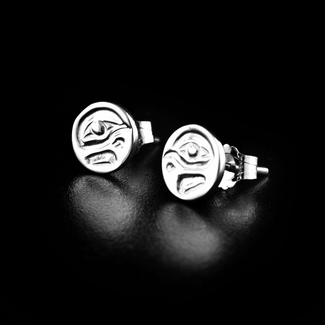 Mini eagle cast studs handcrafted by Kwakwaka'wakw artist Carrie Matilpi. Made of sterling silver. Each earring measures approximately 0.25" in diameter.